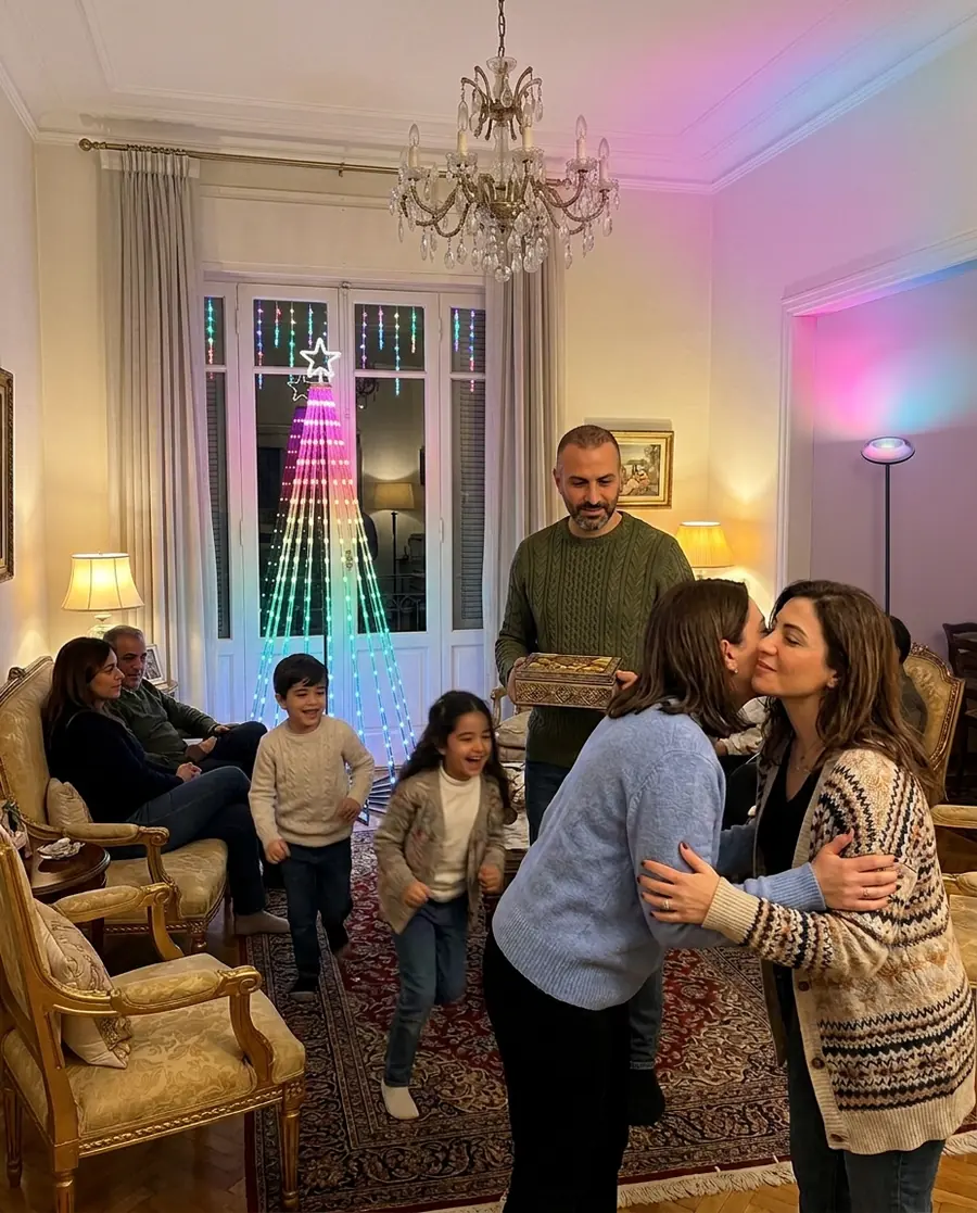 A Govee cone tree of colourful light in the corner of a Lebanese living room with guests arriving